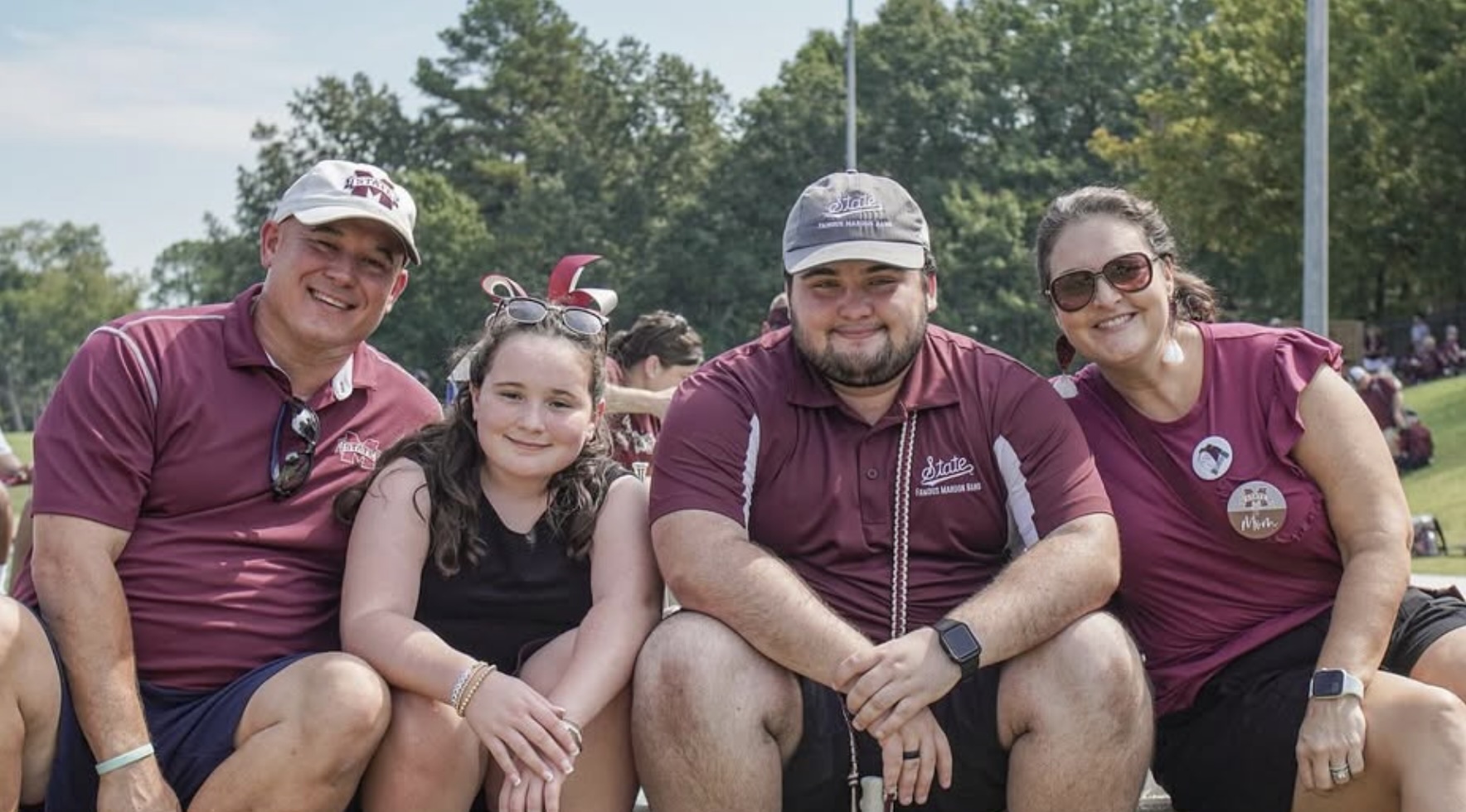 An FMB student smiles while sitting with his family at the 2025 Band Parent Day event.
